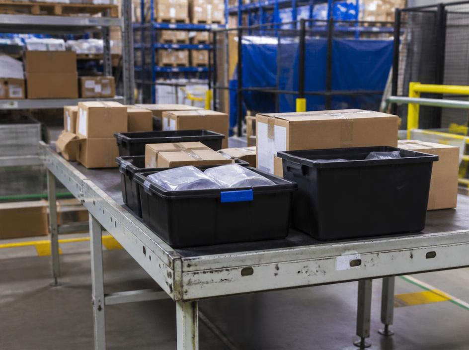 Totes and cartons waiting at a consolidation table